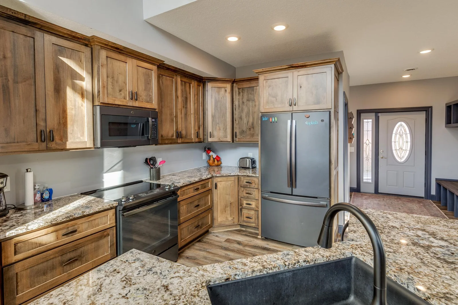 Spacious kitchen with granite counter tops and stainless steal appliances.
