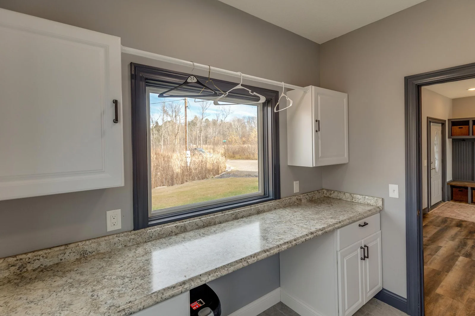 Main floor laundry room with storage.