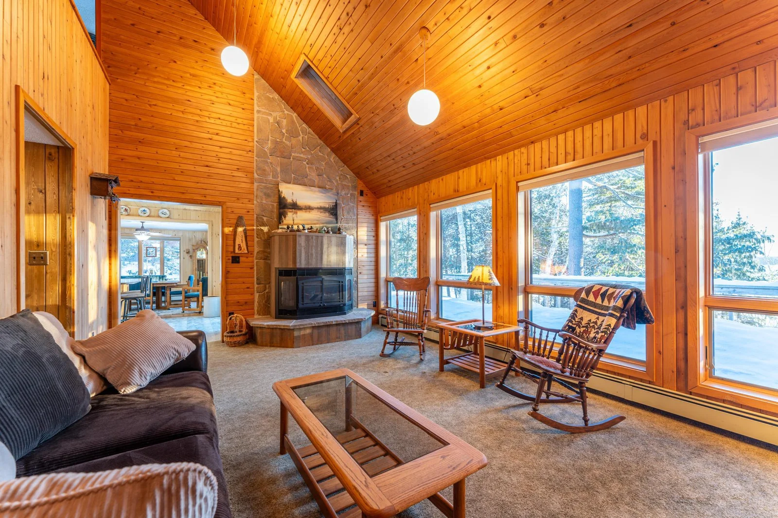 Main floor living room with vaulted ceilings and skylights