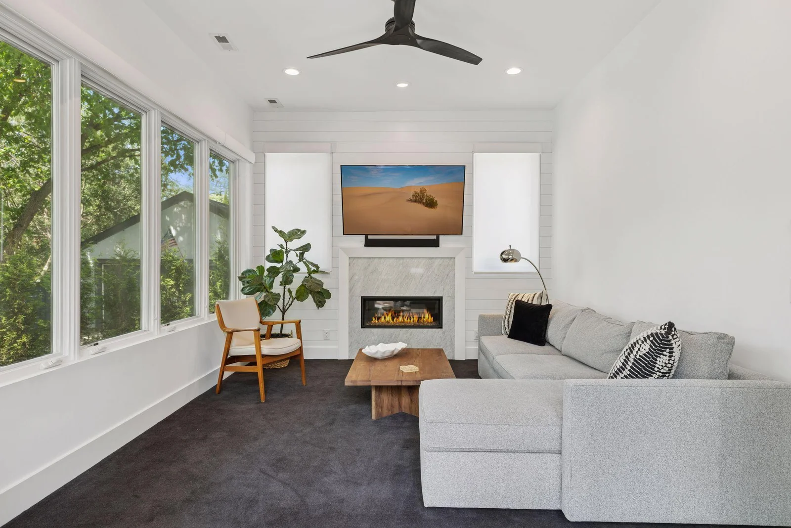 Main level sunroom with fireplace and heated floors