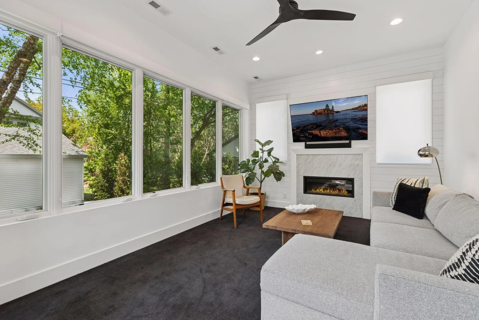 Main level sunroom with fireplace and heated floors
