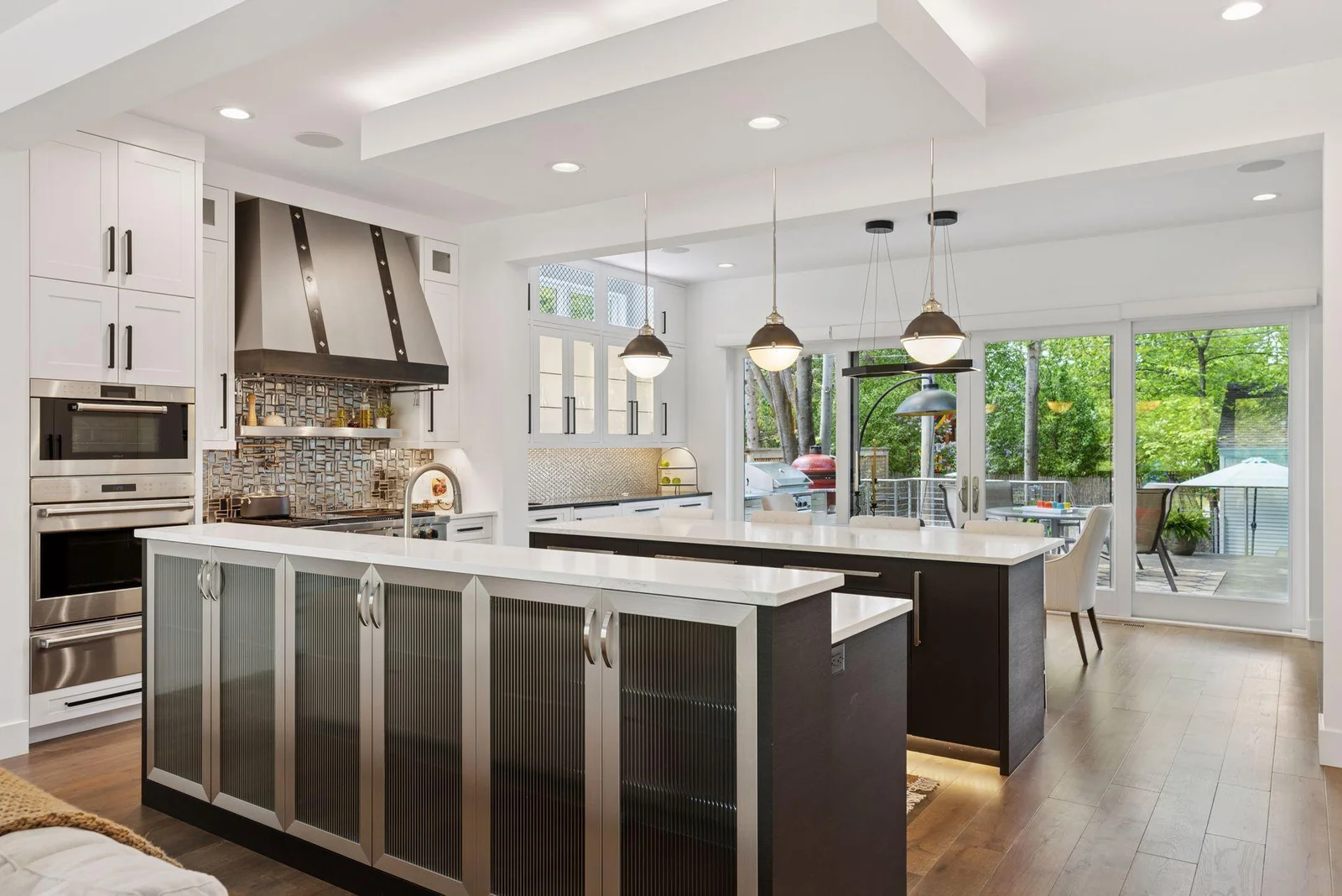 Custom chef's kitchen with 2 huge islands defines and creates very functional spaces on main level