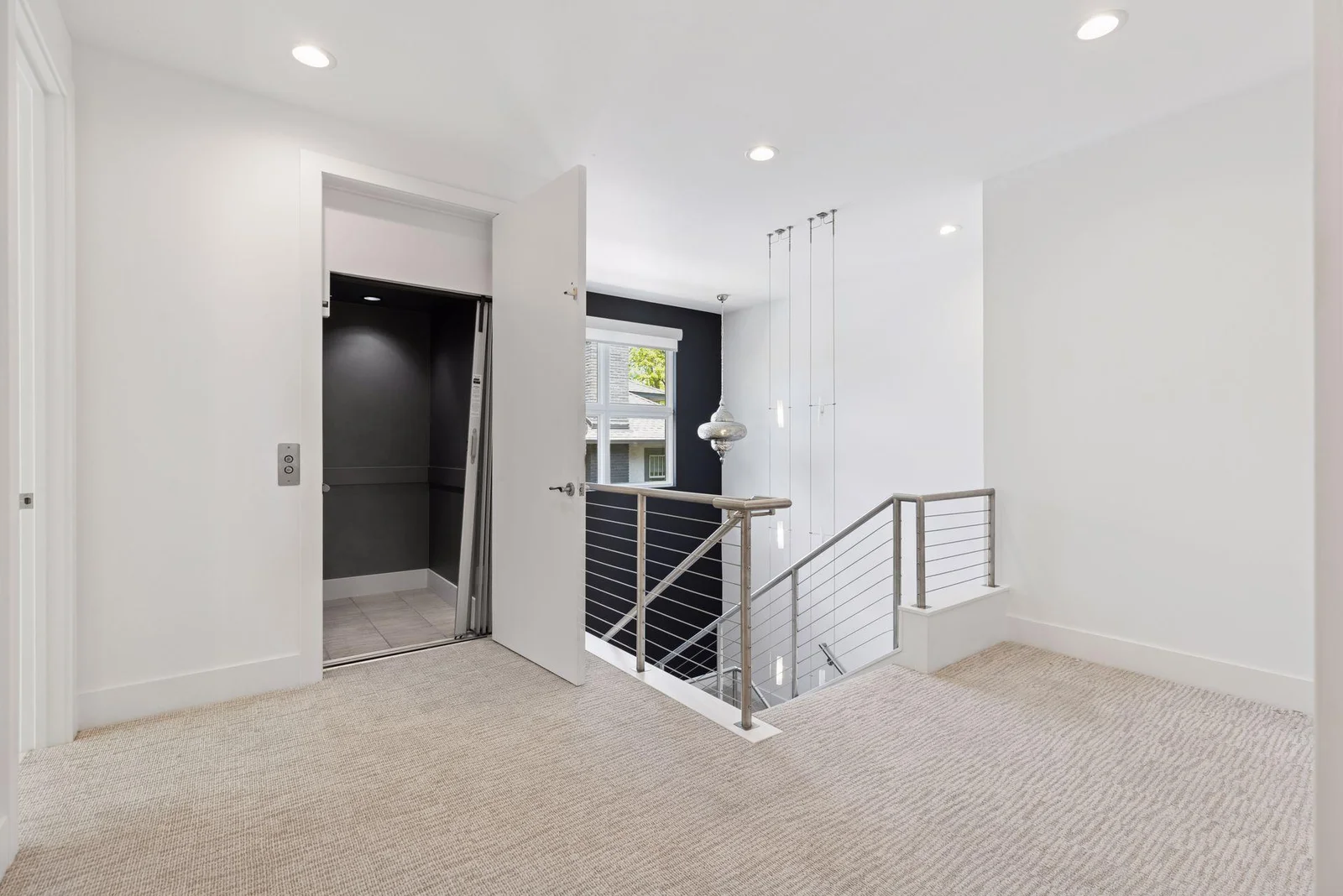 Upper level elevator landing with elevator access to all levels