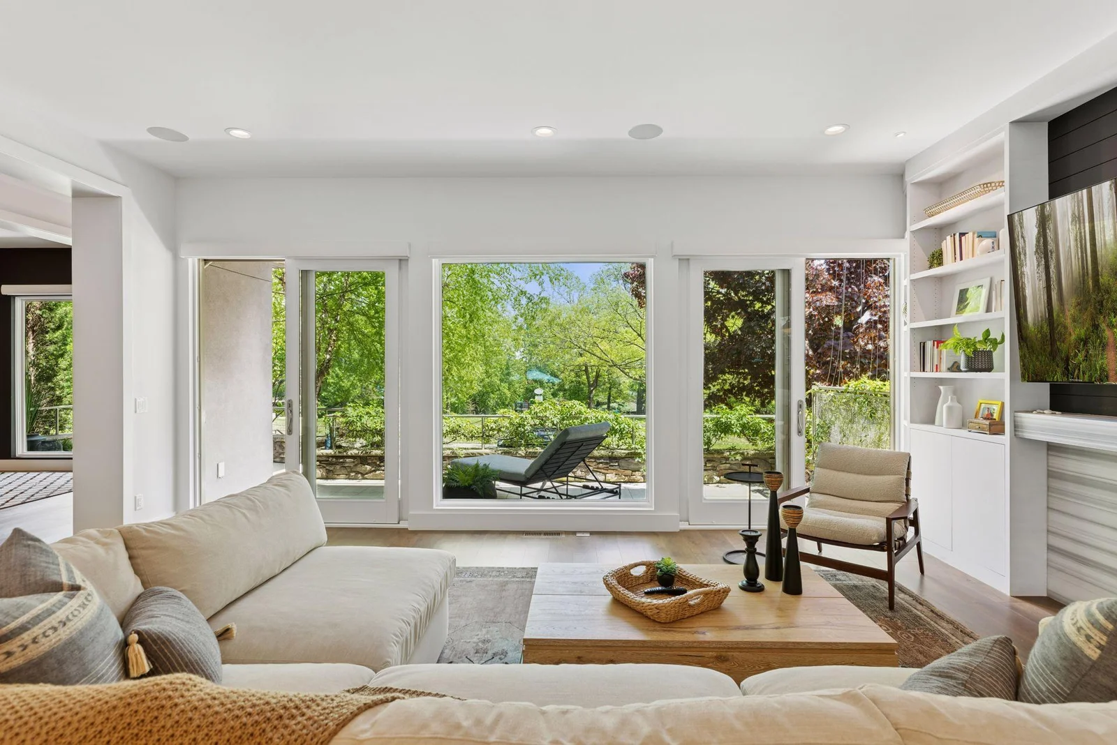 Living room with 2 sliding doors and access to front deck overlooking park and Lake Harriet to the East