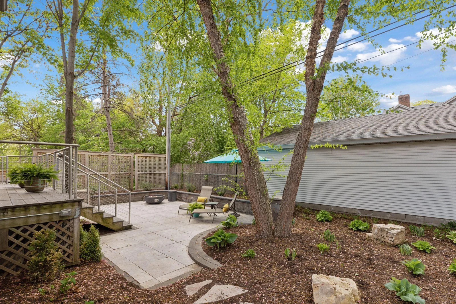 Private lower patio in back with low maintenance gardens