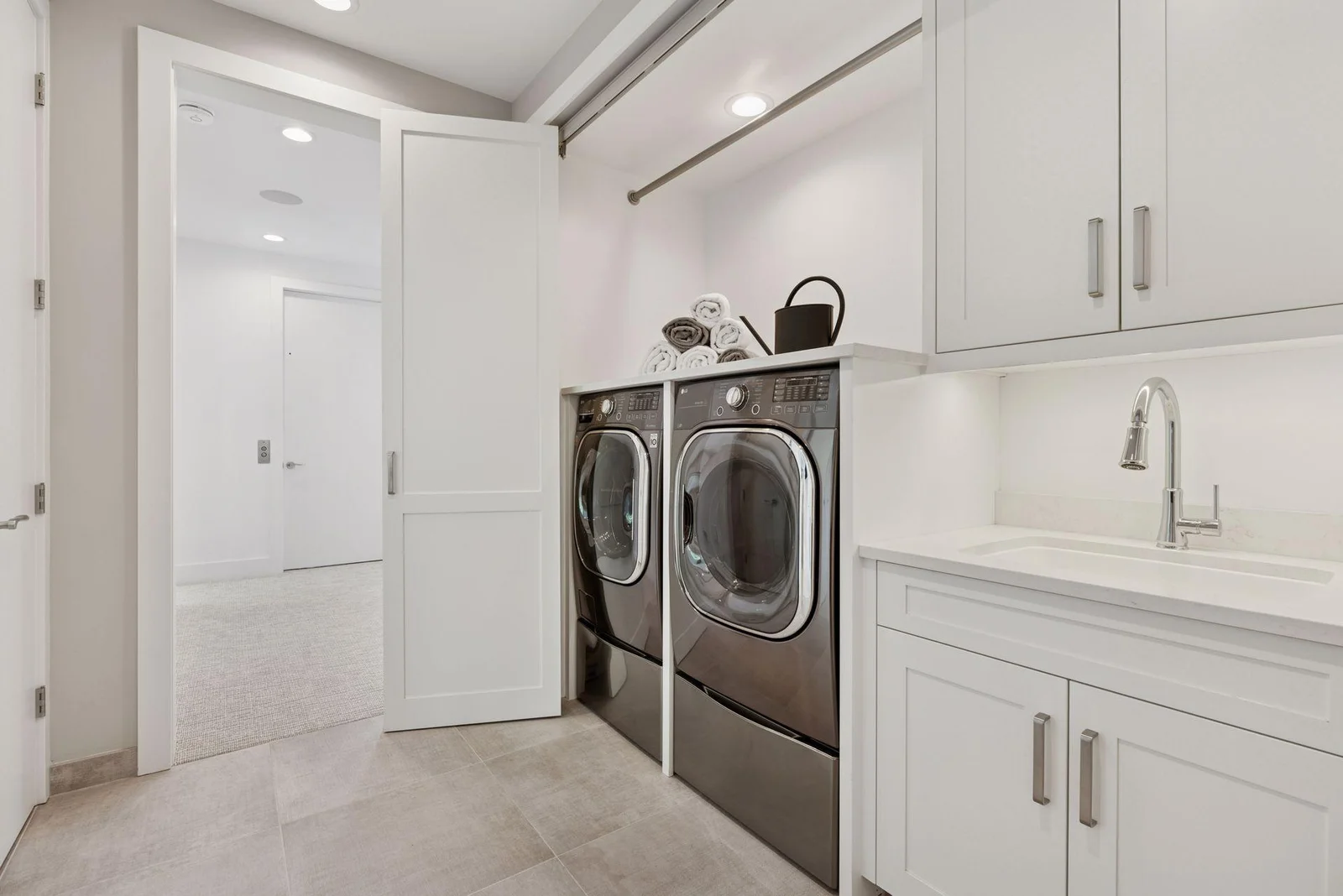 Upper level laundry with custom doors and storage