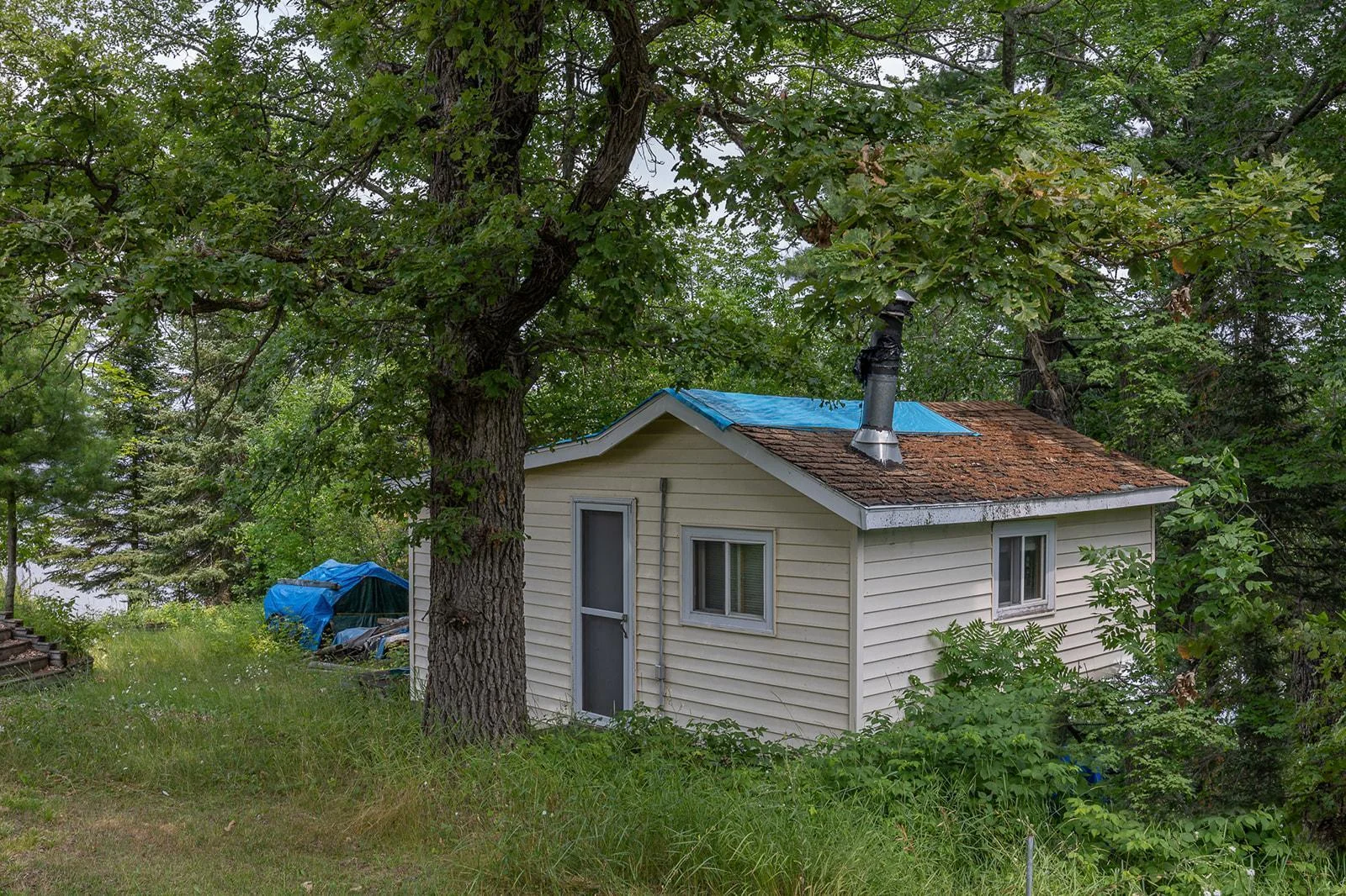 Small guest cabin or storage building selling AS IS.