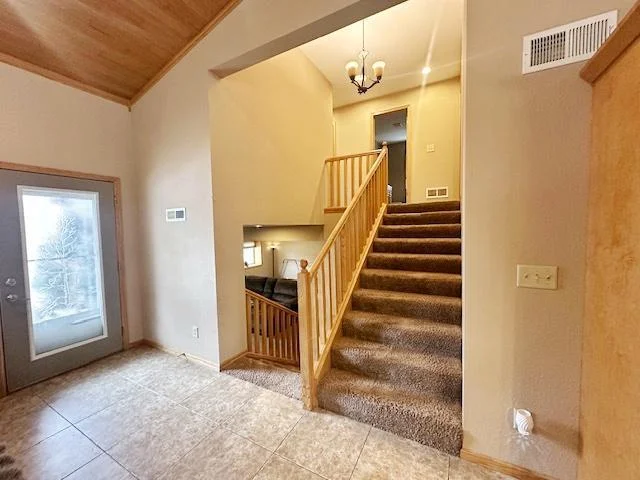 Stairway leading up to bedrooms and to lower level
