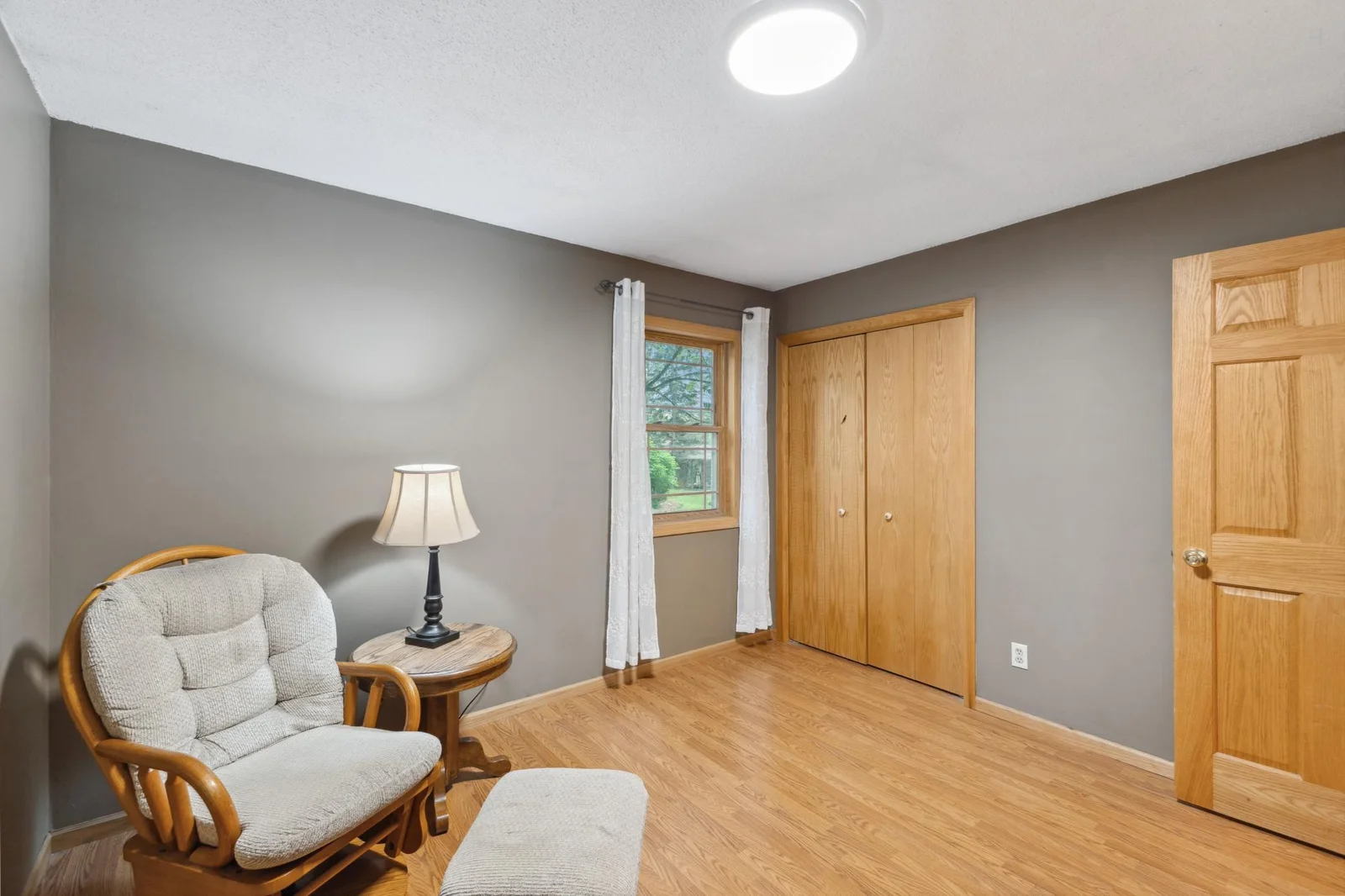 This bedroom being used as an office and has a built-in cabinet.