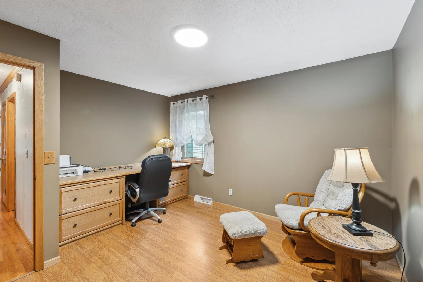 Third main level bedroom with laminate flooring.