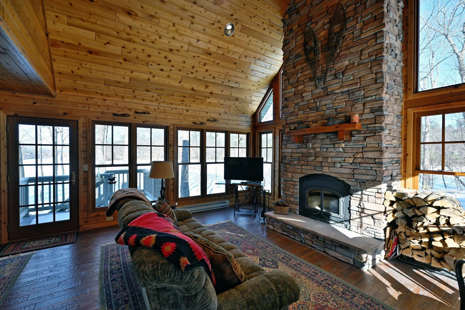 Recently added Sunroom with vaulted ceiling and cozy wood fireplace