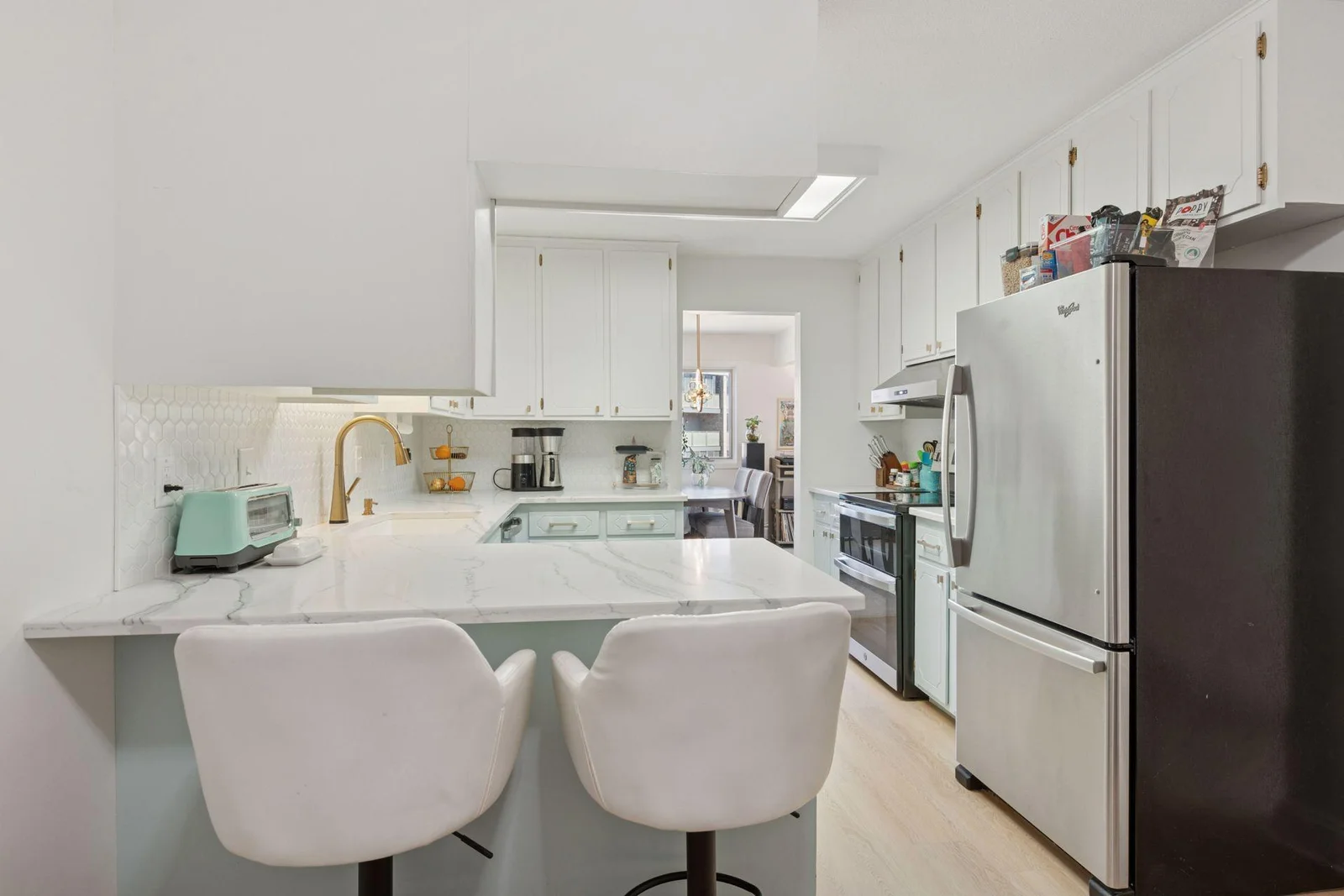 Counter eat in kitchen with new SS appliances, countertop, backsplash, flooring