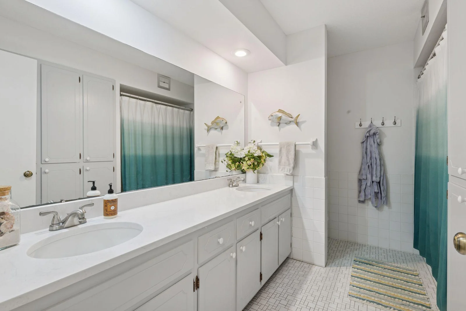 2nd bathrooom with tub dual sinks and shower.