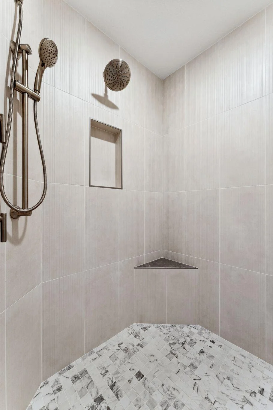 LARGE walk in tiled shower with no glass, plus two corner benches