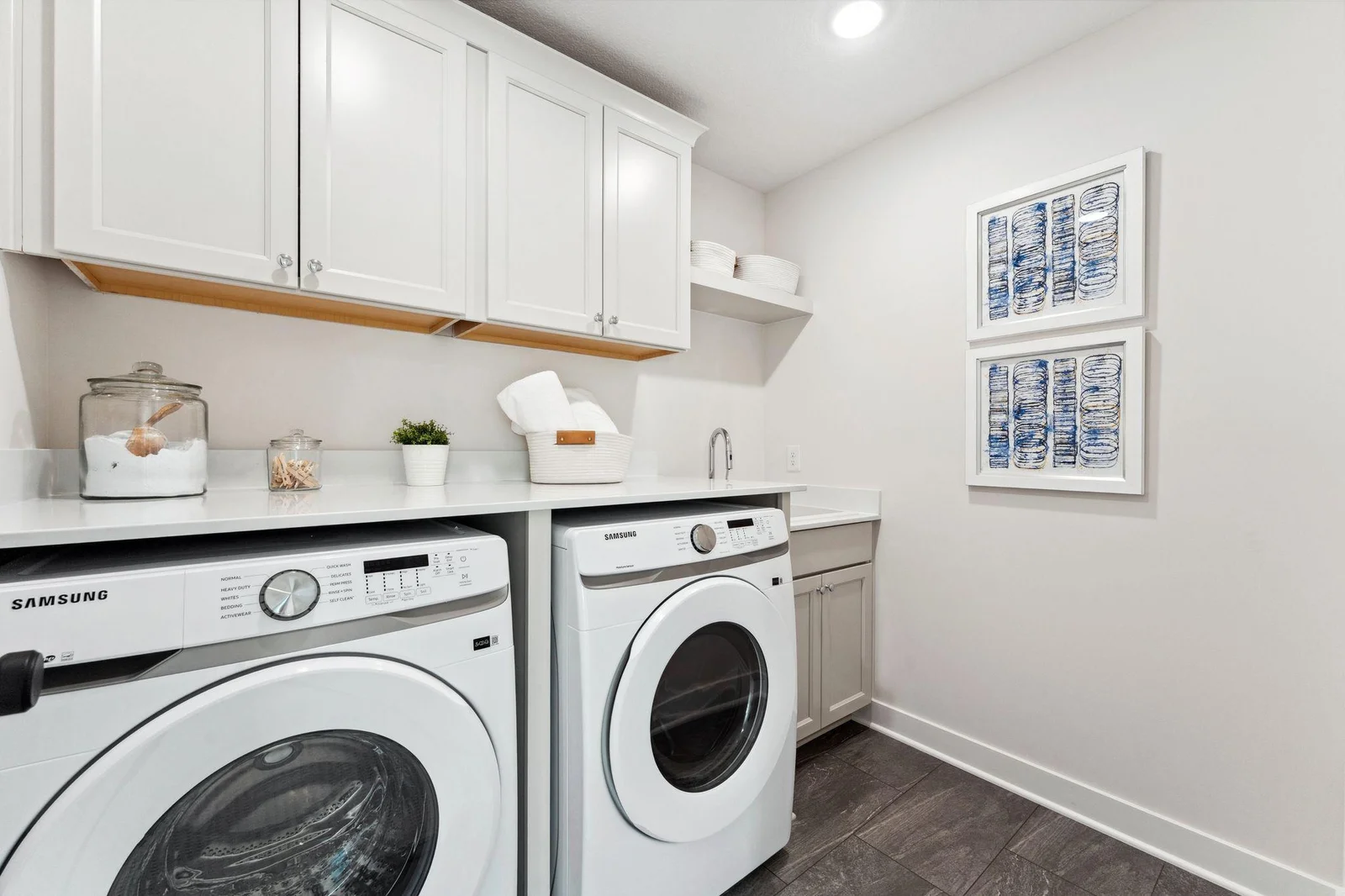 Laundry with cabinets and quartz countertops
