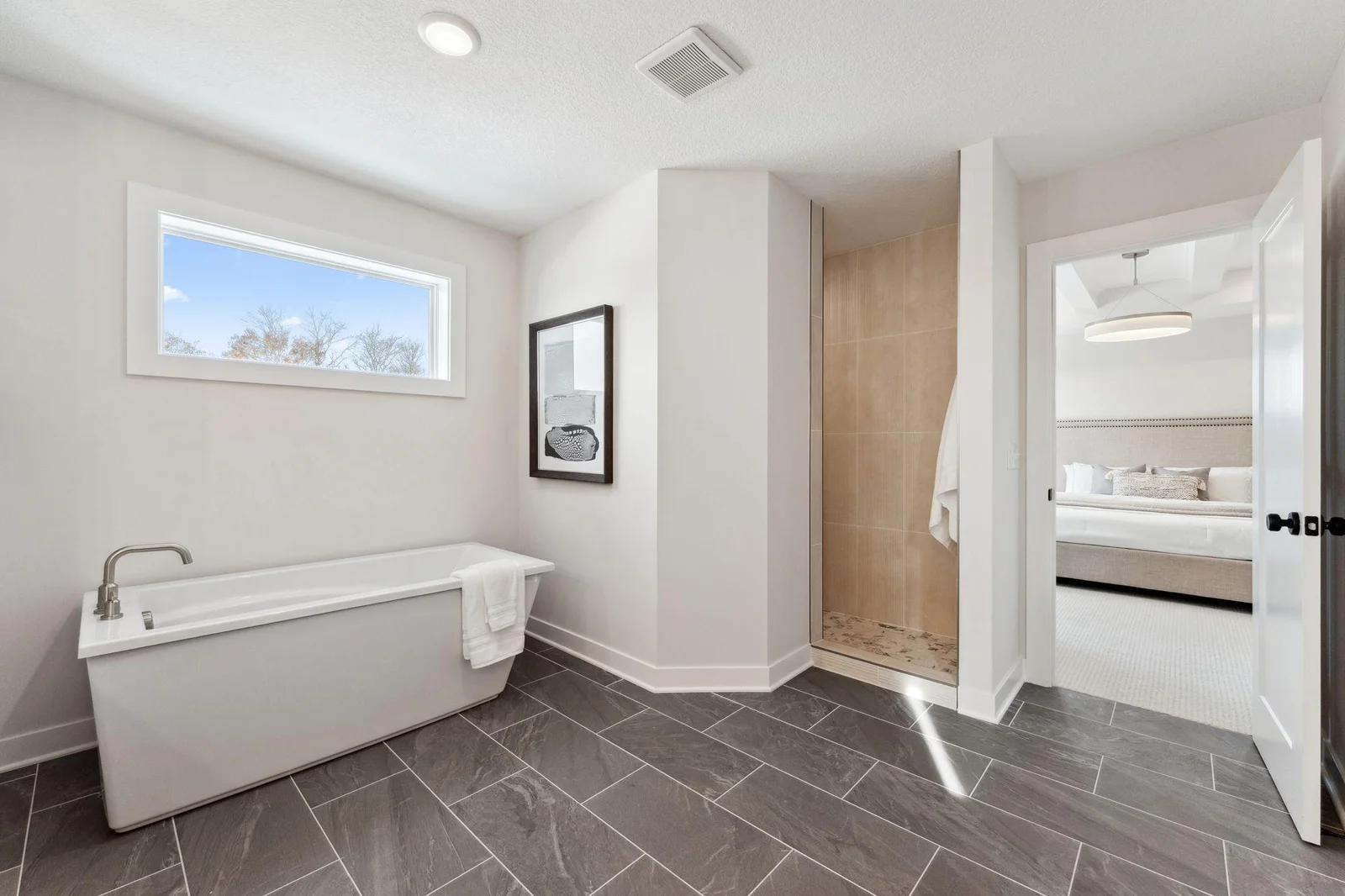 Freestanding soak ing tub with oversized walk-in tiled shower