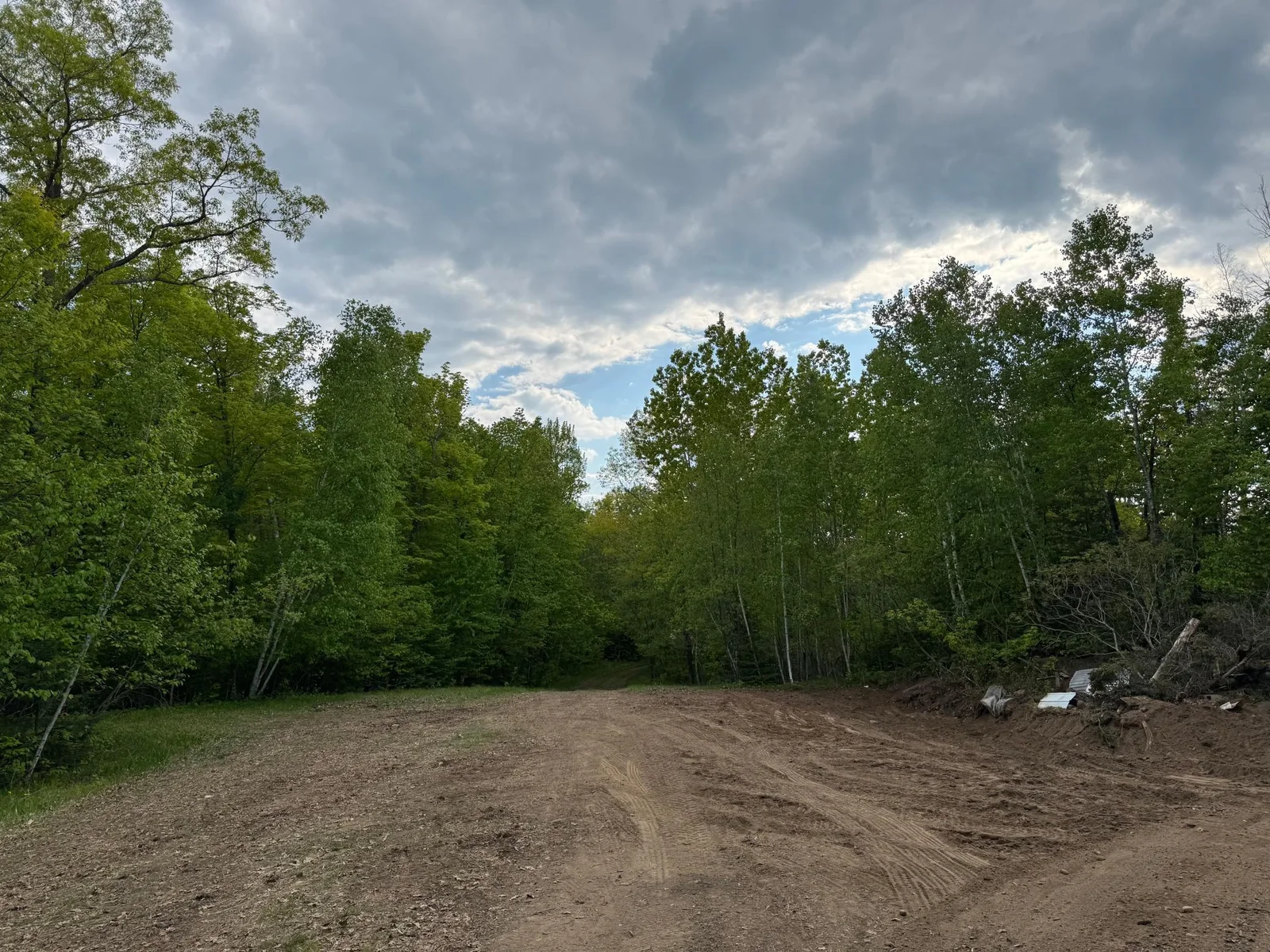 First open area you reach as you enter the property.  This would make a great building site amongst the trees.