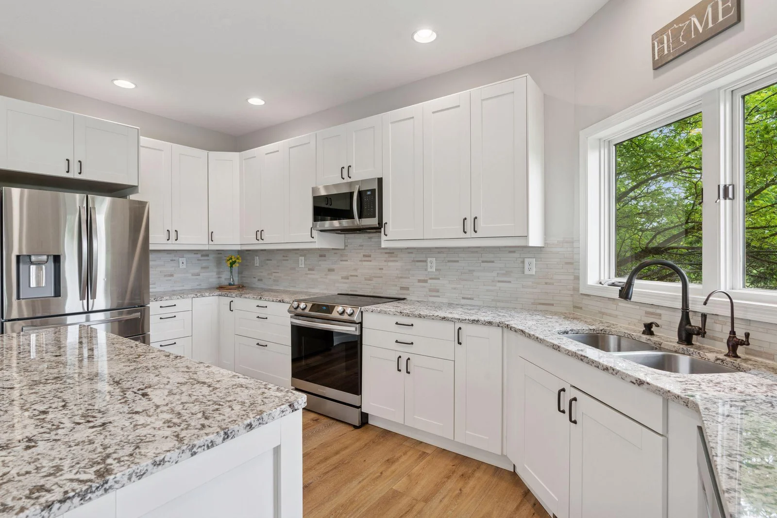 Granite Countertops with multi-colored tile backsplash