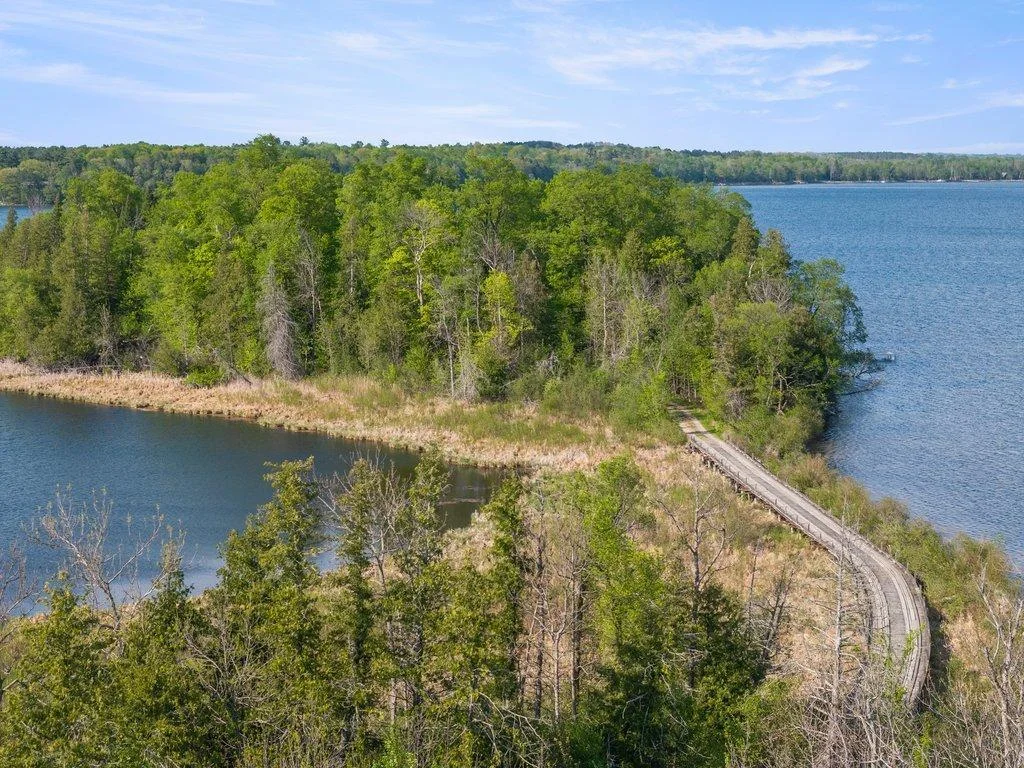 Drone shots of bridge driveway into the property. Bridge is reinforced with metal beams