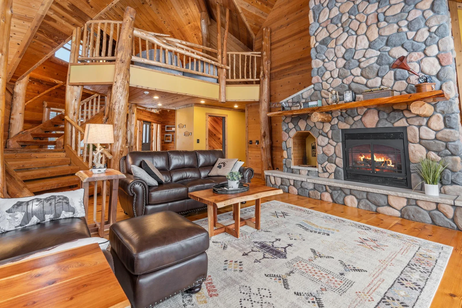 living room with log accents and gas FP
