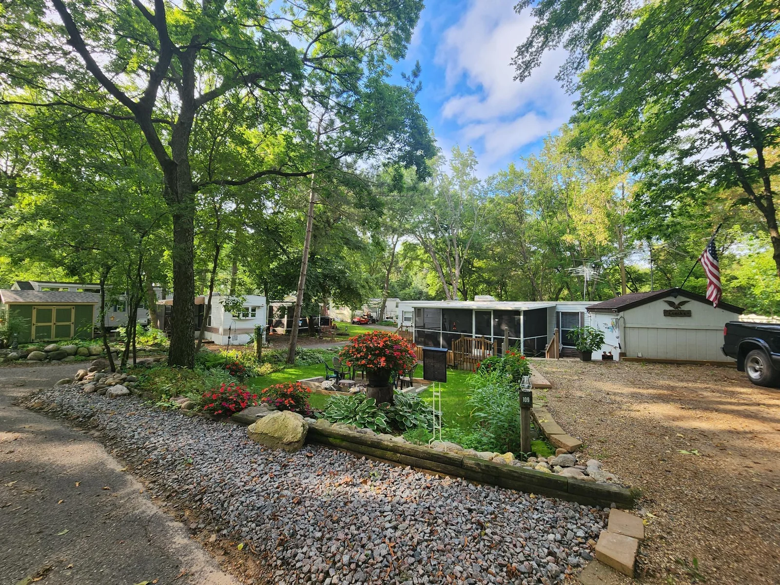 Unit 109 Cokato Lake RV Resort Cooperative has a 2010 Breckenridge Destination RV and Quality-built Sun Room; ample parking, shed, outstanding landscaping and many other shared amenities including a 550 acre 50+ foot lake!