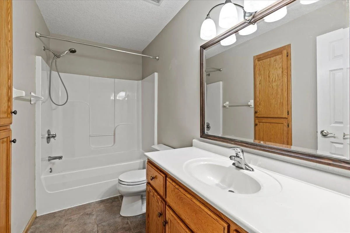 A second bathroom with room for all your accessories AND a tub/shower plus a laundry storage? Yes, please.!