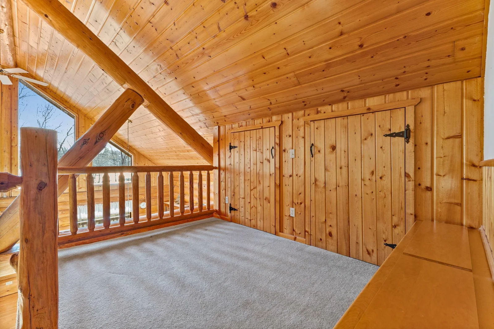 Another view of the sitting area with ample storage areas. Cozy and comfortable, ideal for reading, relaxing, or enjoying the scenery.