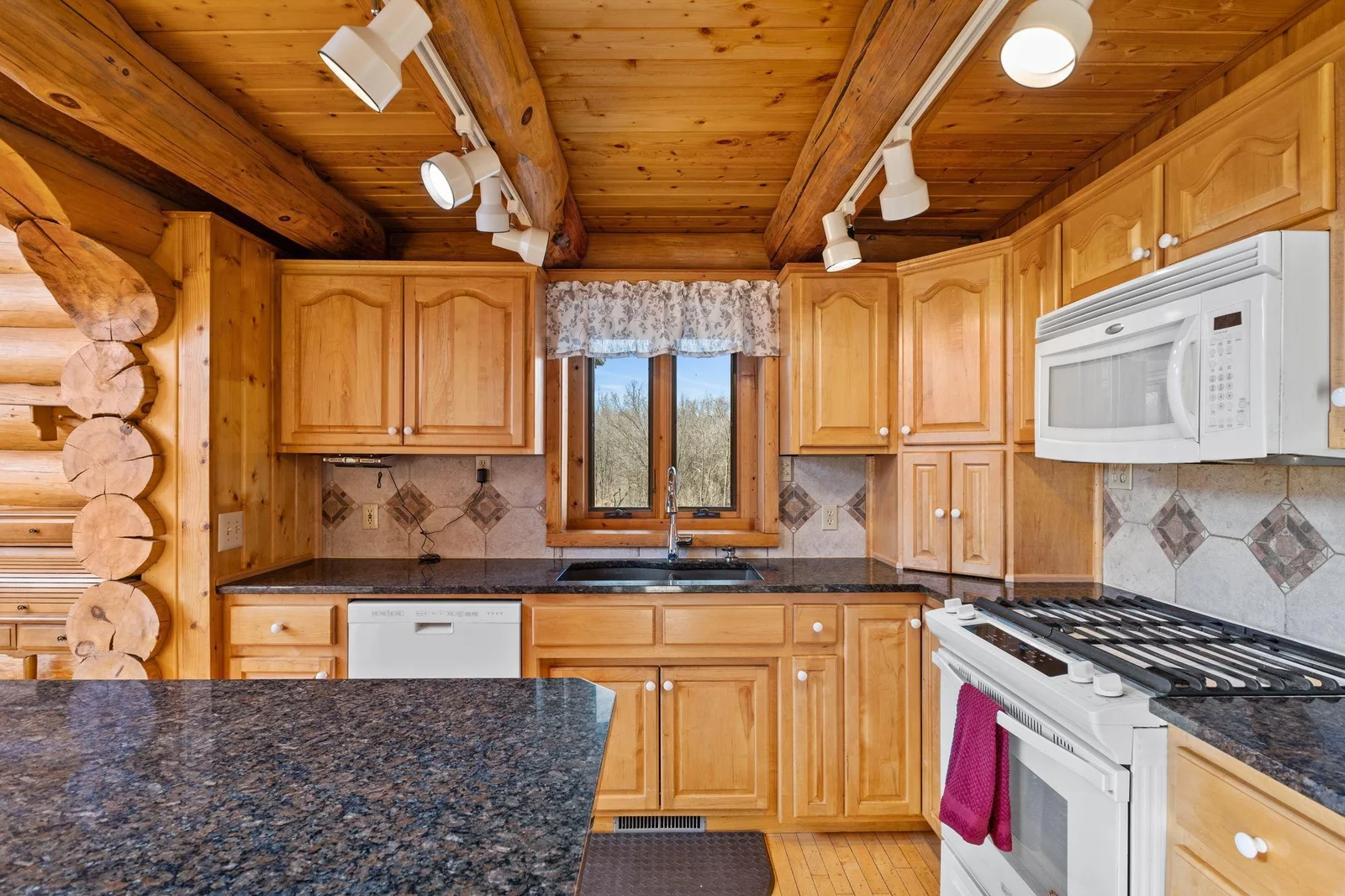 Step into this beautifully crafted kitchen, where elegance and functionality come together. The hardwood floors add warmth and sophistication, while the custom kitchen cabinets provide ample storage and a seamless design.