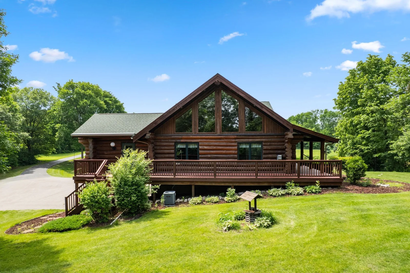 The highlight of the property is the expansive wrap-around deck, offering panoramic views of the picturesque surroundings. Perfect for unwinding, the deck provides ample space for outdoor dining, lounging, and enjoying the fresh cup of coffee.