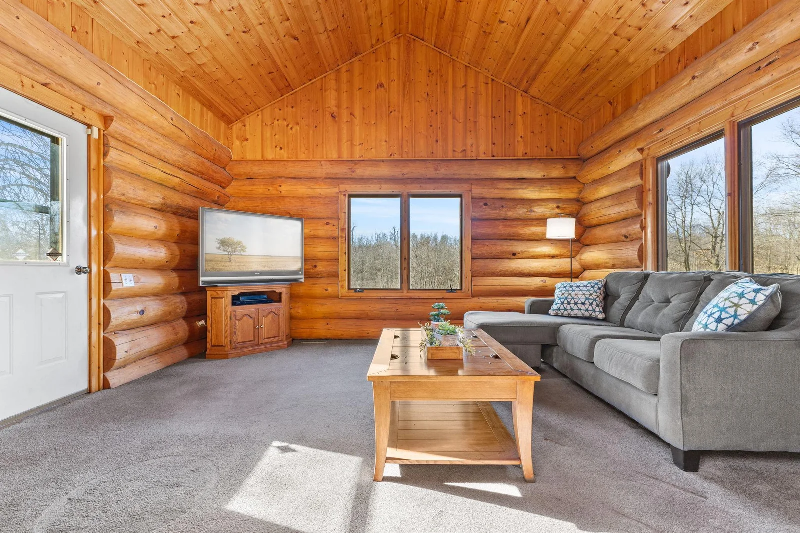 Relax and unwind in this inviting 4-season porch, perfect for enjoying a good book or watching a movie. This versatile space offers comfort and tranquility throughout the year, with large windows that provide beautiful views and ample natural light.