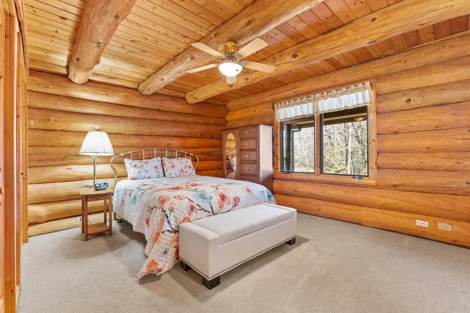 Enjoy the tranquility of nature in this beautifully designed main floor bedroom. The large windows offer stunning views of the pond, creating a peaceful and relaxing atmosphere. Picturesque pond view, providing a serene and calming backdrop.
