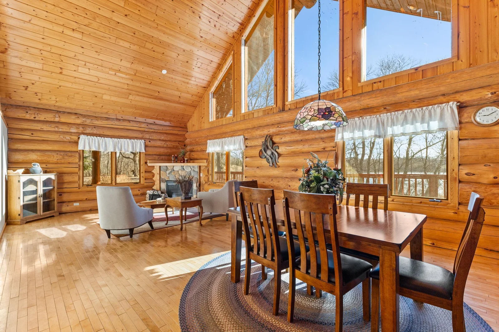 Enjoy meals in this beautifully designed dining room. The hardwood floors add warmth and sophistication, while the windows offer stunning views of the lake, creating a serene dining experience.