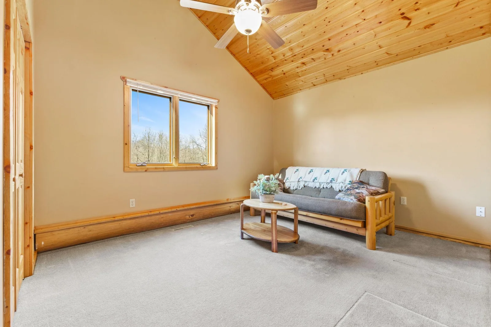 This flexible space can serve as either a third bedroom or a home office, featuring a vaulted ceiling that adds a sense of openness and elegance. Whether used for rest or productivity, this room offers a comfortable and inviting atmosphere.