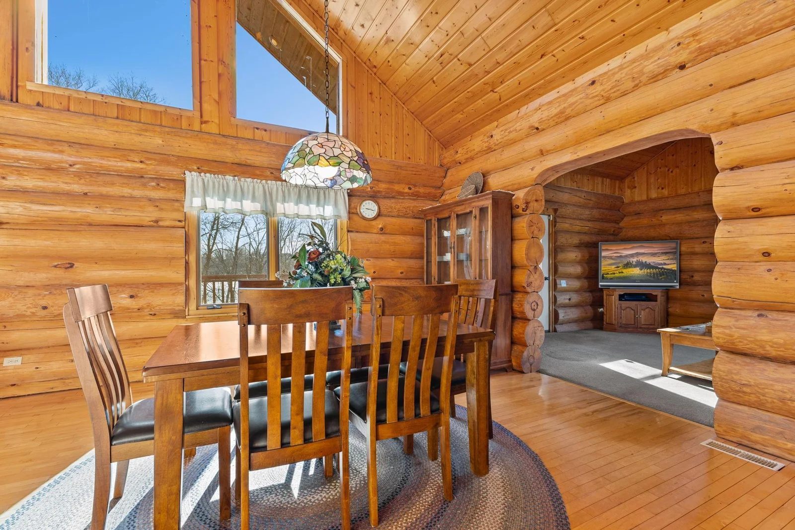 From the dining room, step into this versatile 4-season porch, conveniently located off the dining room. This space is designed for year-round enjoyment, offering a cozy retreat with beautiful views and ample natural light.
