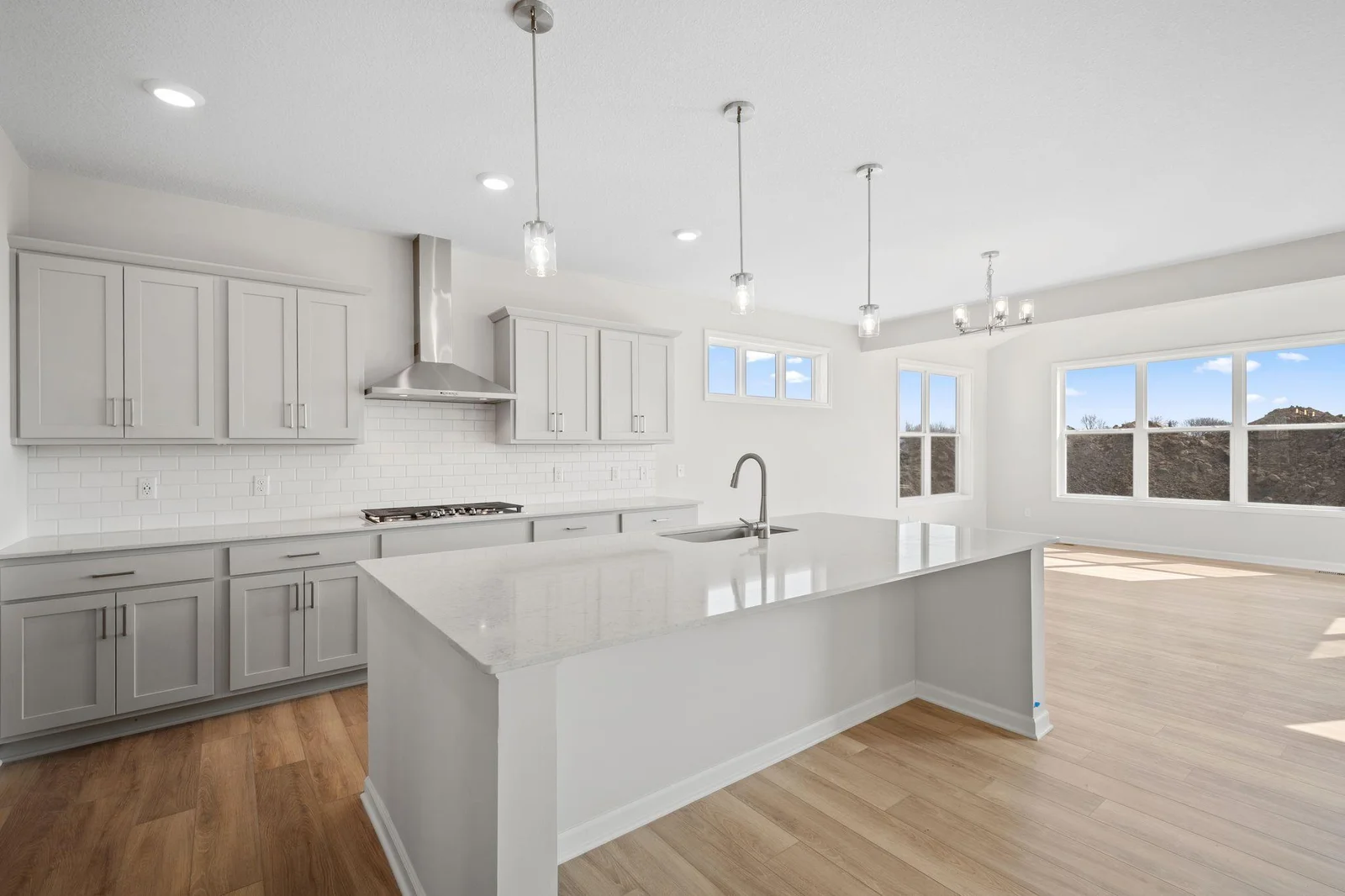 Your new contemporary kitchen features gleaming stainless steel appliances, a spacious island for meal prep or casual dining.  (Picture of actual home.)