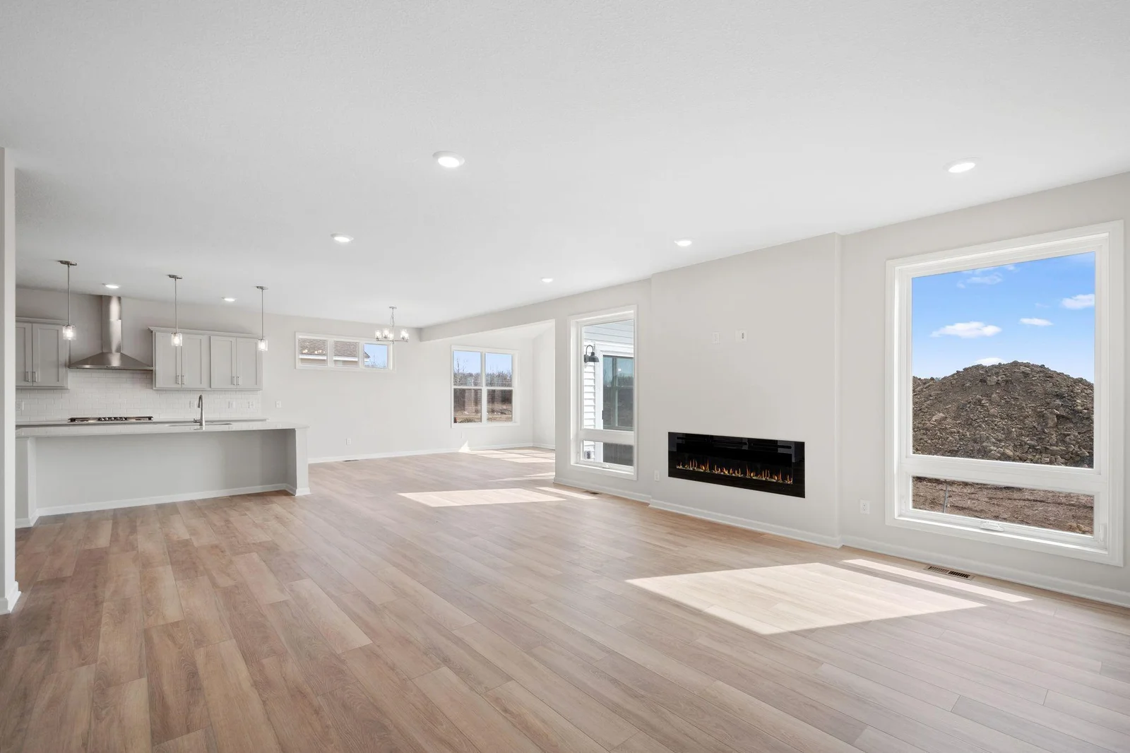 Enjoy yet another striking perspective of the expansive living area, where the open-concept design connects the kitchen and morning room in perfect harmony!