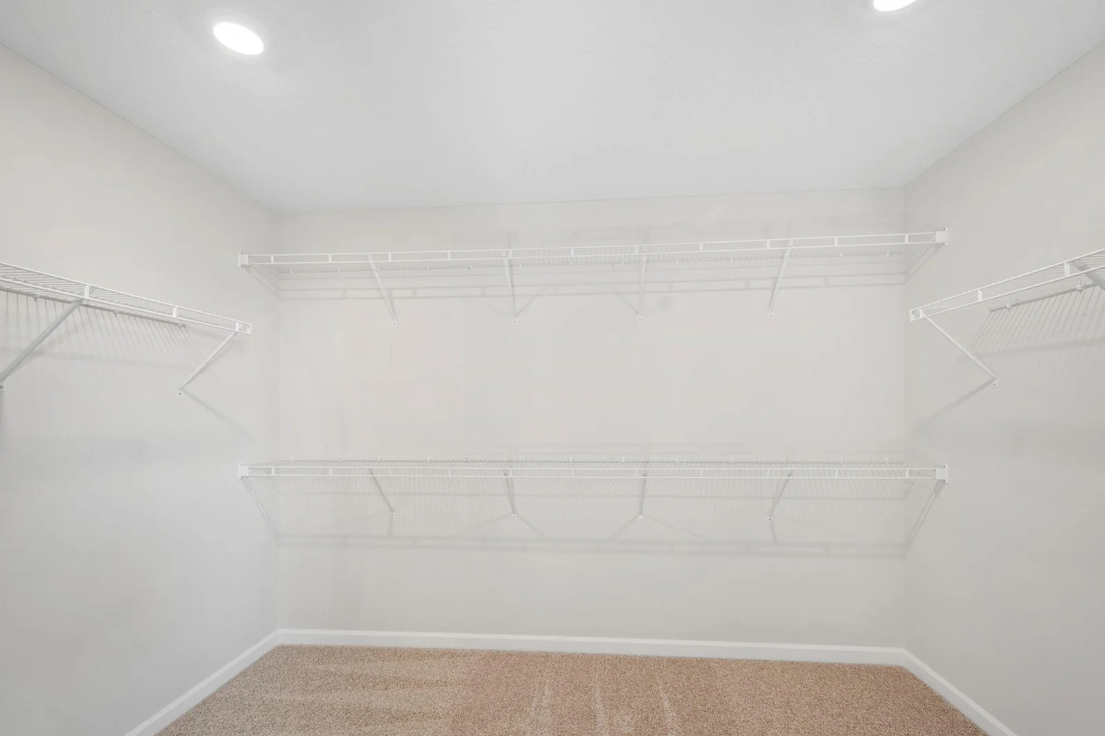This owner's suite includes a generously sized walk-in closet, offering boutique-style storage with plenty of room to customize and organize!