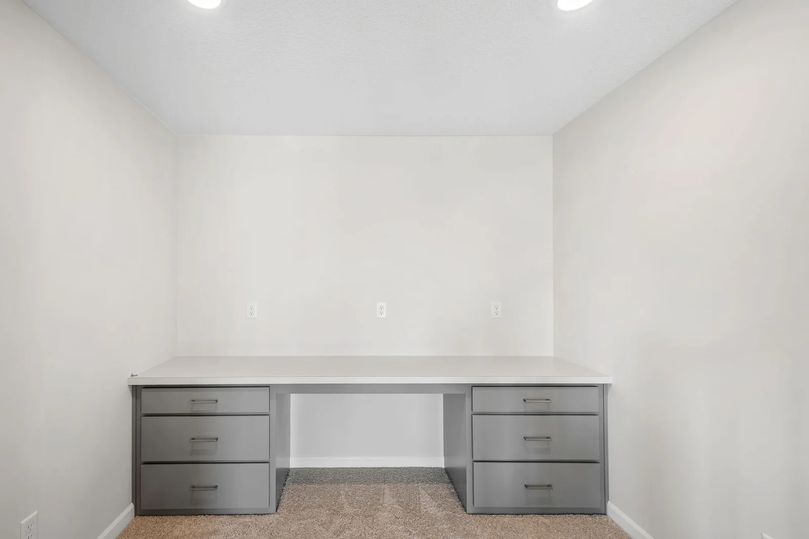 Thoughtfully designed tech nook features a built-in desk, ideal for a home office setup, study station, or daily planning space.