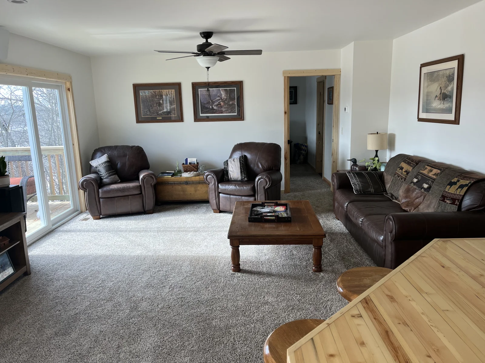 The living room is cozy with the deck access out the patio door.