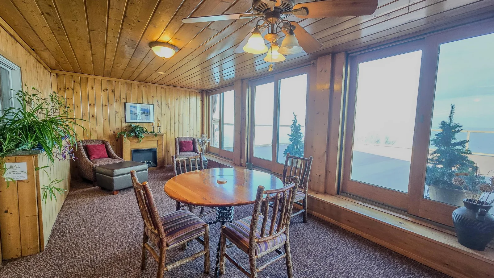 Dining table and cozy reading nook with 2nd fireplace in the main lobby