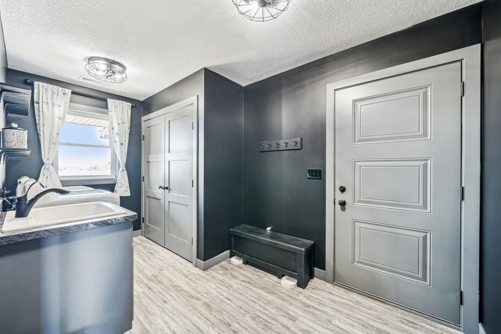 Laundry room with closet and garage entry