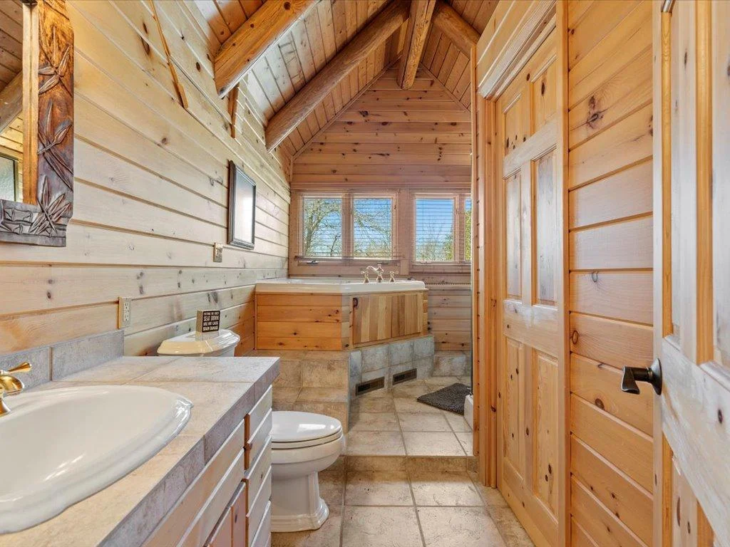Primary bath, 2nd view.  Raised jetted tub with great natual light.