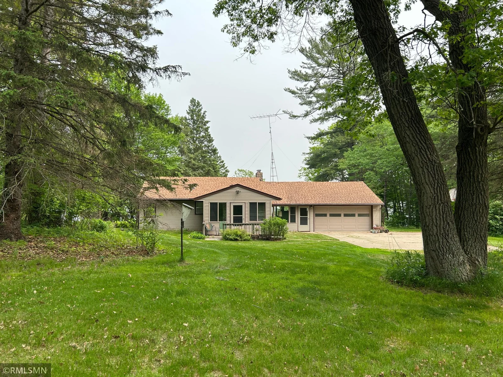 Beautiful shot of front of home featuring mature woods throughout.