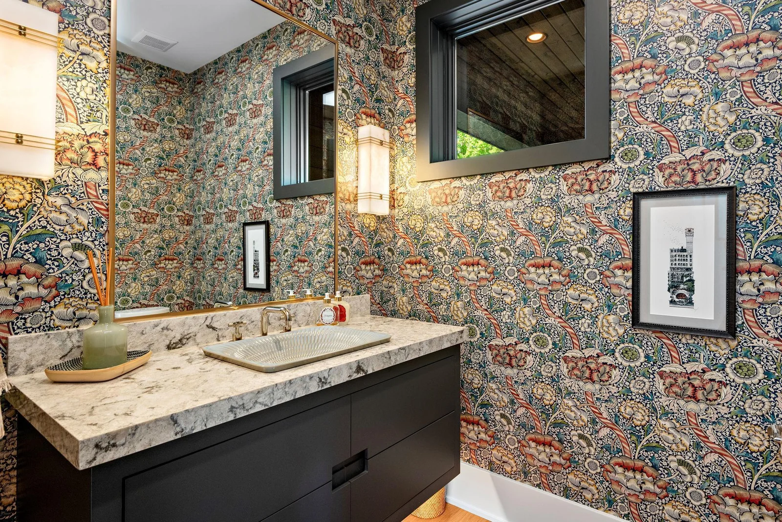 If ever a loo was described as a private oasis, this is it. Gently illuminated by warm wall sconces and under-cabinet lighting, the wallpaper radiates the same inviting warmth as the heated seating - embracing those who pause to linger and reflect ;)