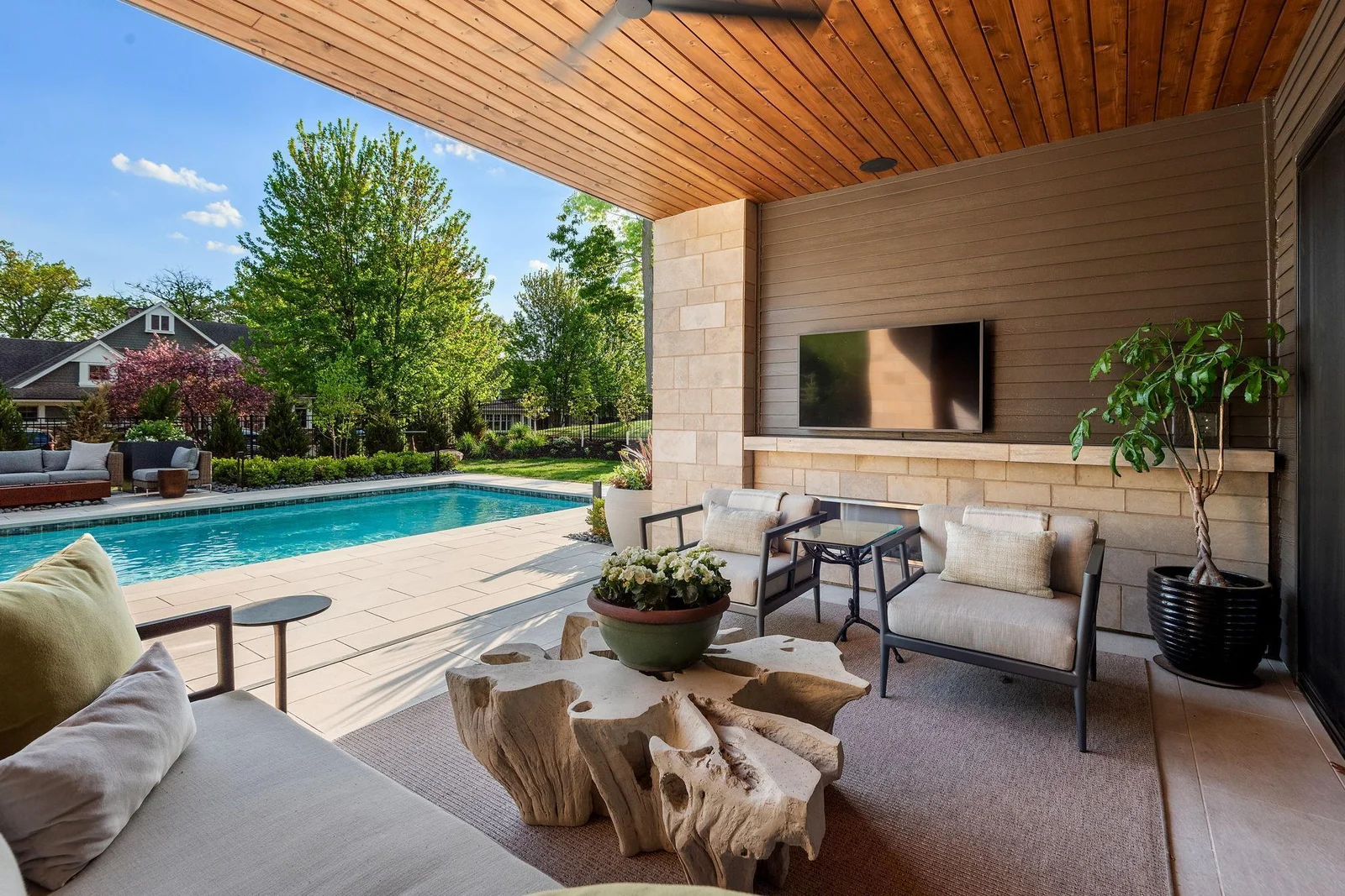 Retreat to the poolside lanai, complete with built in Hearth & Home fireplace, mere steps away from the Baja deck & pool