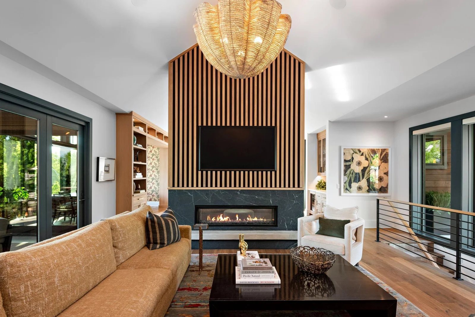 Gas fireplace on main and another is directly below anchoring the walk-out lower level. The entire front of the home, as well as, the garage are dressed in Lutron shades which can be operated by remote or from your mobile phone, wherever and whenever