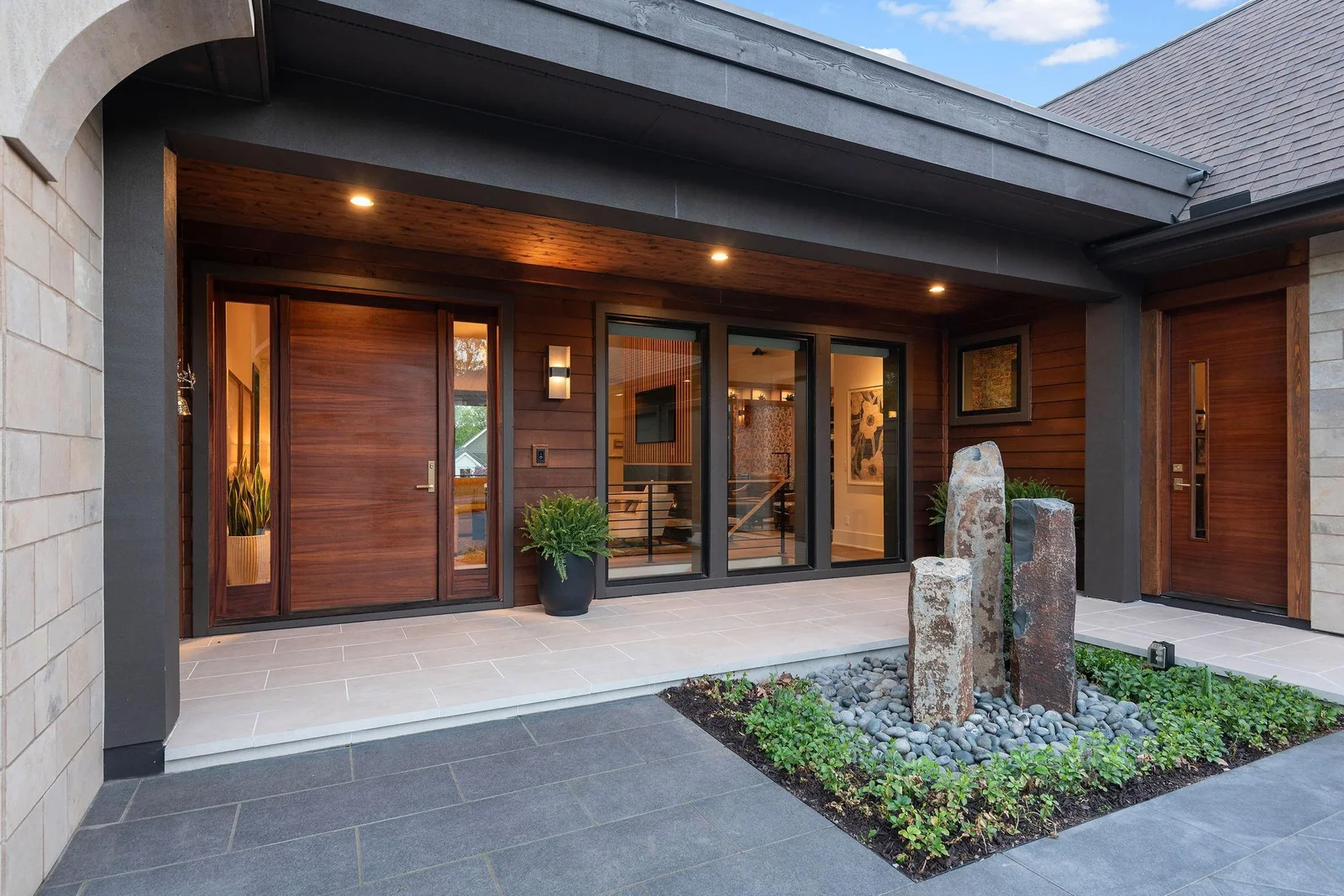 Guests are greeted by the natural sounds of the custom designed fountain, bringing the front entry to life even before traditional greetings are exchanged. Absolutely a must feel! 16" x 32" Acido Bianca Porcelain Pavers anchor the front entry.