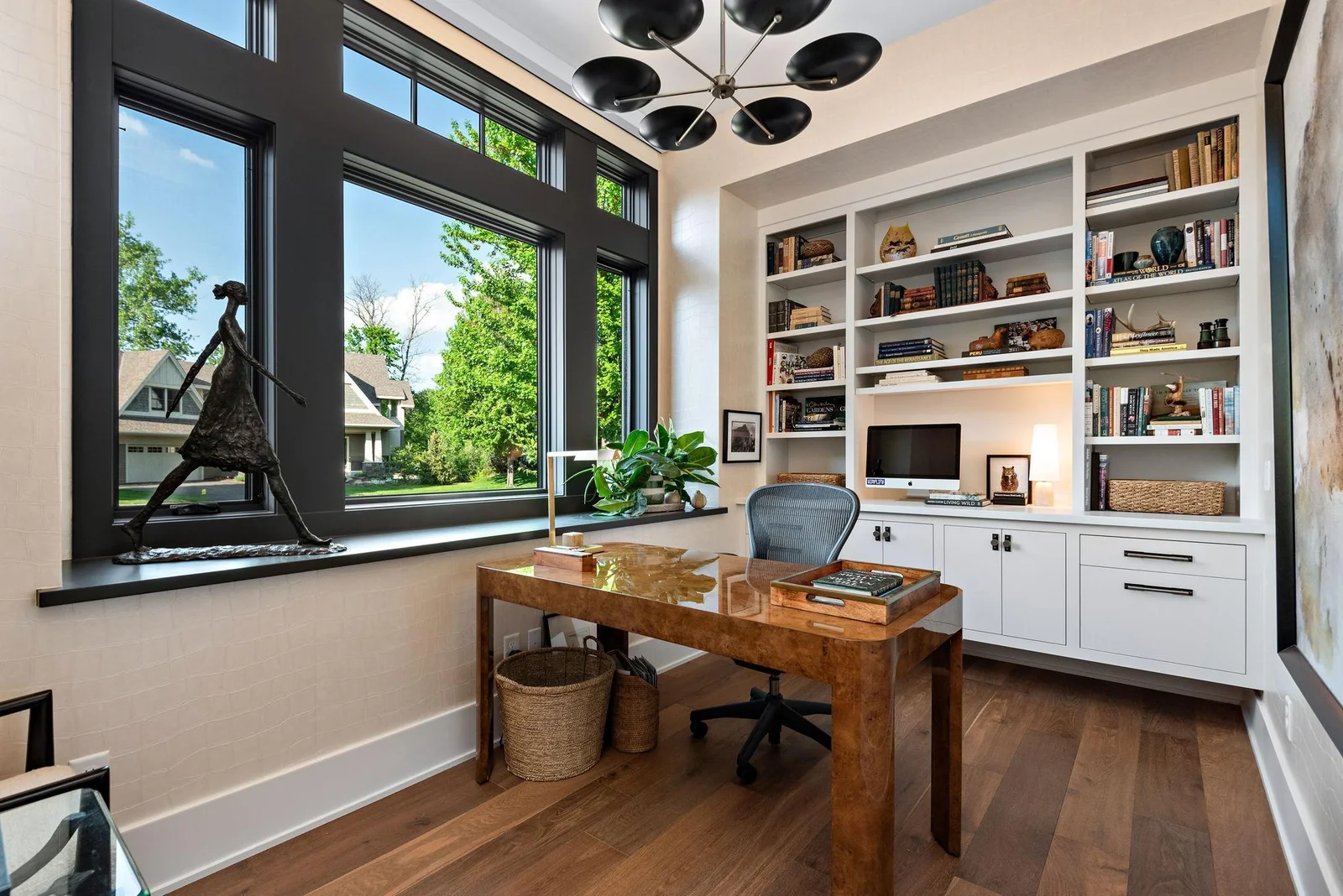 Private Den offers abundant natural light and custom cabinetry designed with features specific to a desired work from home space.