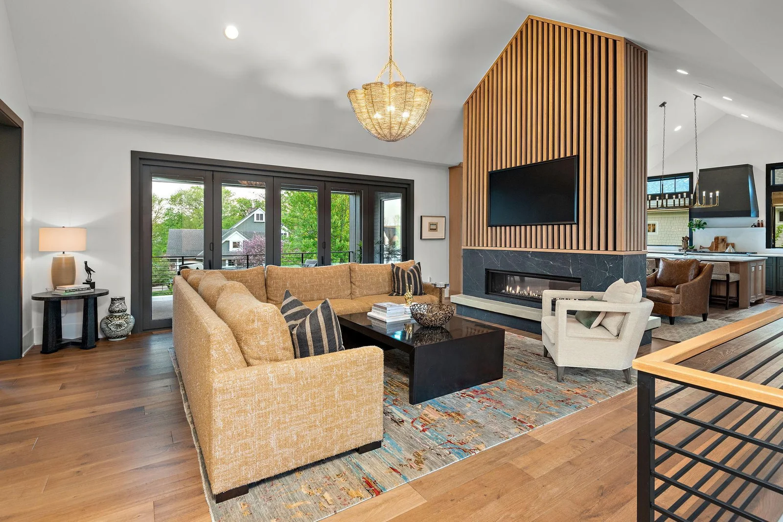 The Gathering Room boasts 14-ft vaulted ceilings, floor-to-ceiling 5-panel bi-folding stackable door system, and 8" wide-plank engineered white oak flooring. The chandelier is absolutely exquisite!