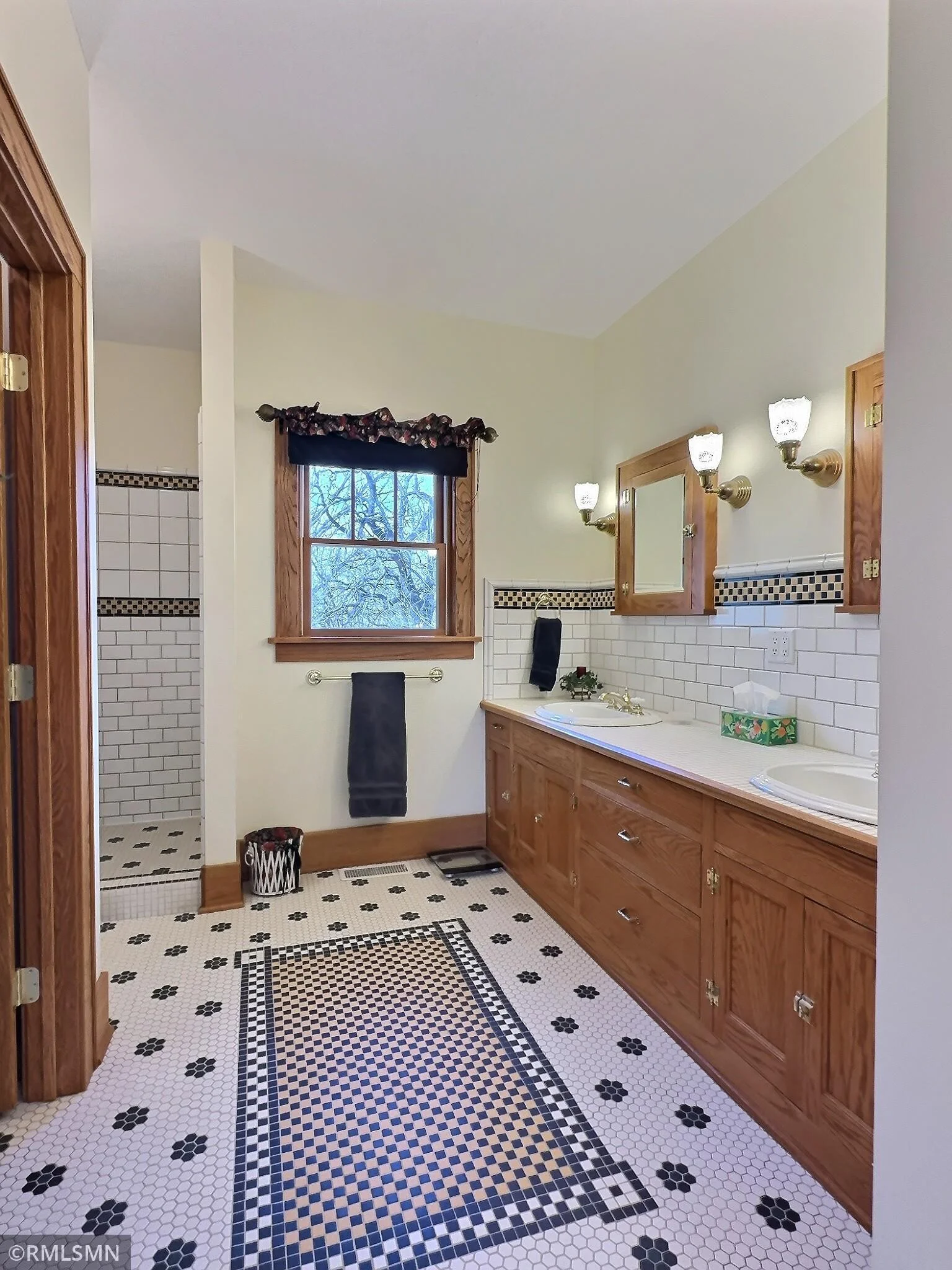 Custom tile, electric in floor heat, double sinks, walk in shower and walk in closet. This bathroom is attached to the primary bedroom.